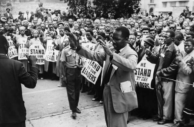 ANC supporters pray in front of the Johannesburg courthouse on Dec. 28, 1956