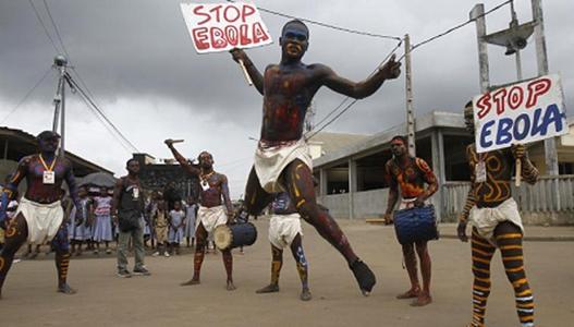 Actors parade on a street during campaign against Ebola